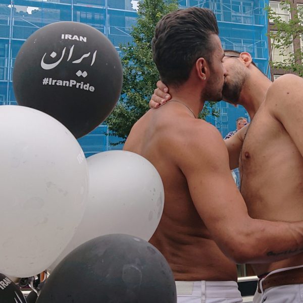 Two boys kissing on the Iran Pride Boat 2019 - By: Raham Rafiee